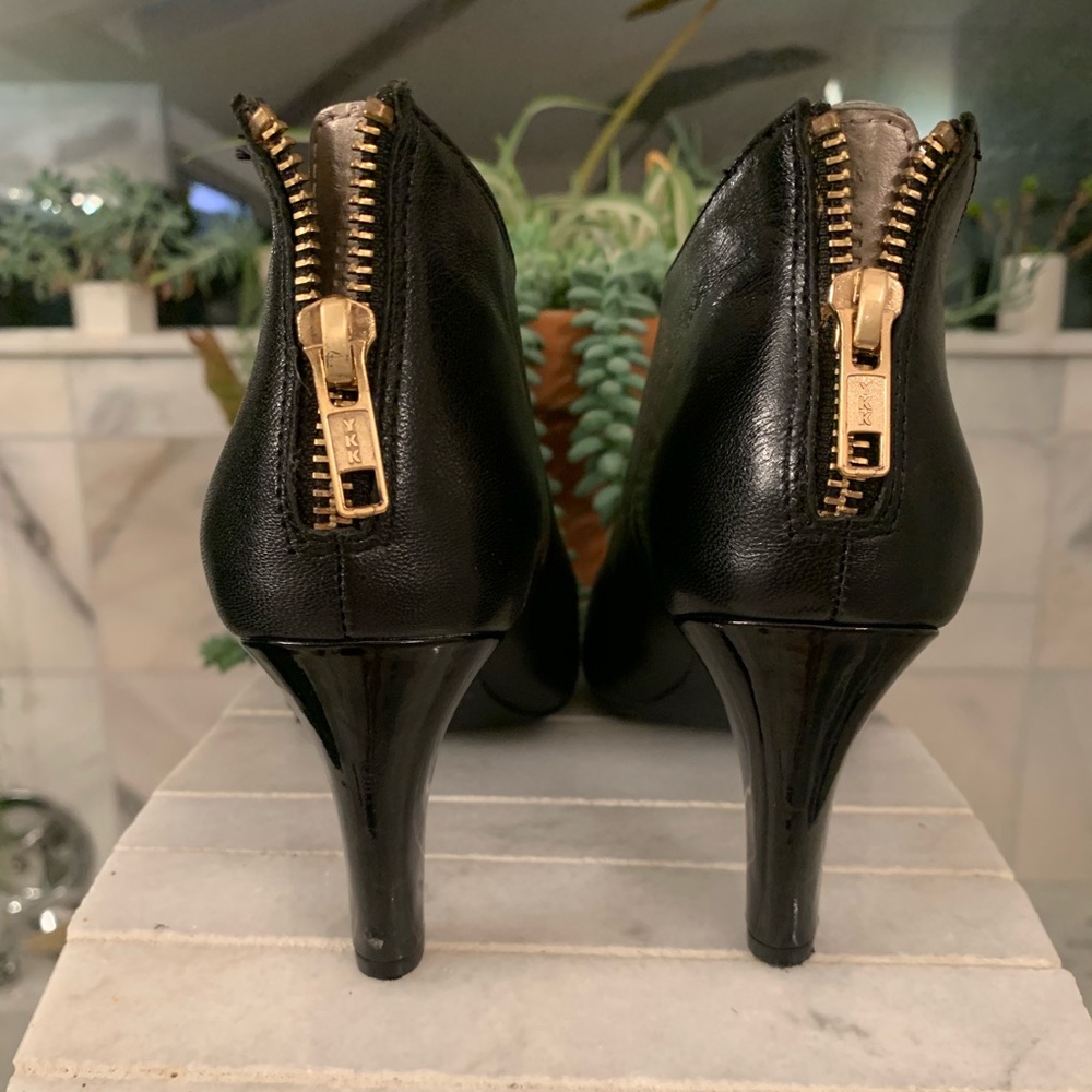 Black leather booties with gold zipper
